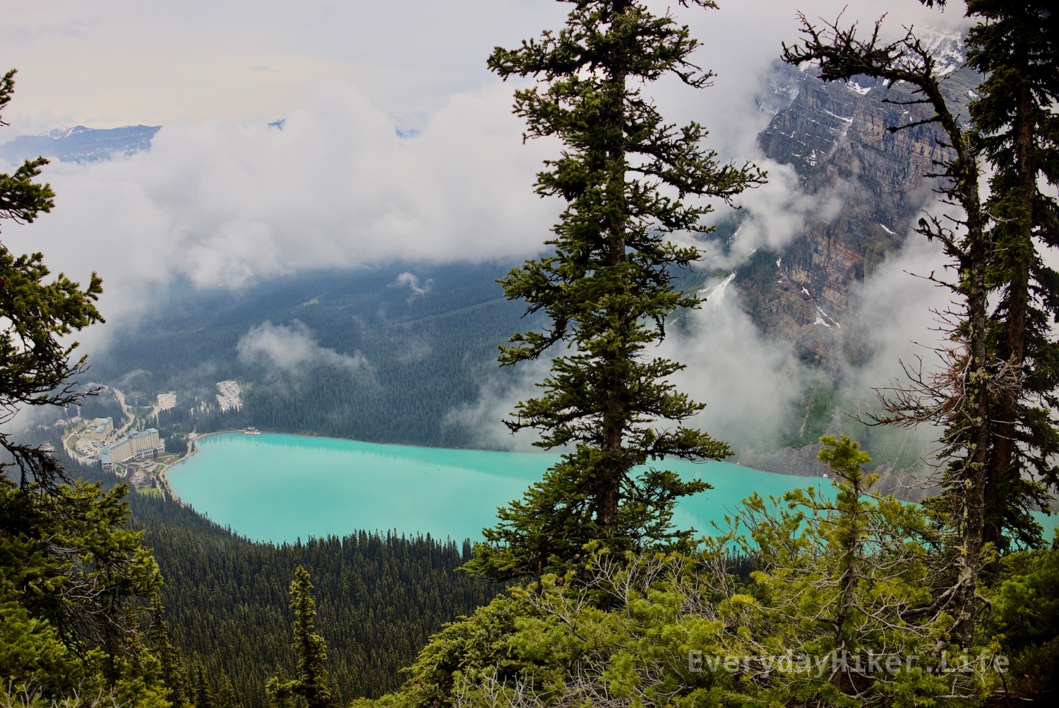 Lake Louise with its stunning turquoise water sits infrom of the Lake Louise Hotel, as seen from the Little Beehive.
