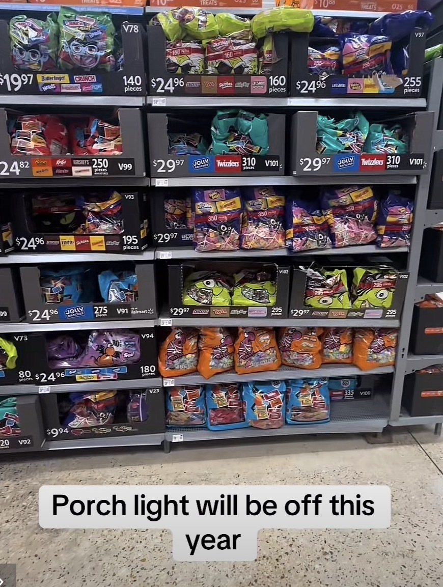 Picture of candy packages in a store advertised for $24-29 each with the caption “Porch light will be off this year“