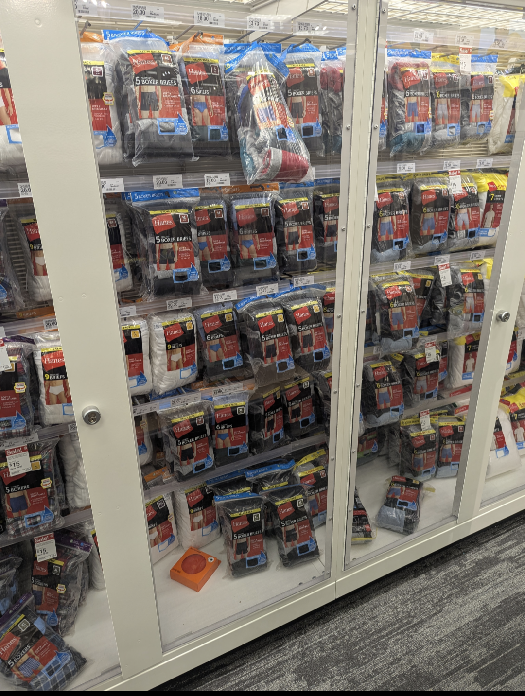 A shop display with Mens underwear locked behind glass.